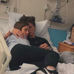 a man and woman cuddling in a hospital bed