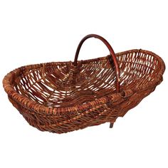 a brown wicker basket with handles on a white background