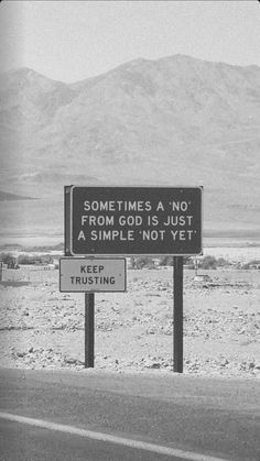 a black and white photo of a sign on the side of the road that says sometimes a no from god is just a simple not yet