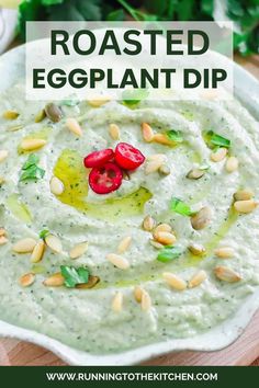 roasted eggplant dip in a white bowl topped with pine nuts and garnish