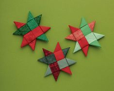 three origami stars on a green surface