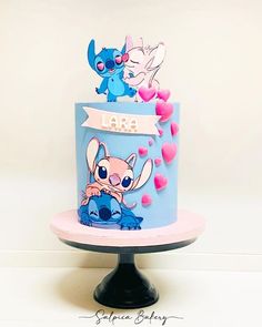 there is a blue cake with cartoon characters on it