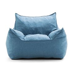 a blue bean bag chair sitting on top of a white floor next to a pillow