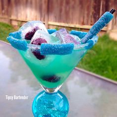 a blue and green drink sitting on top of a table