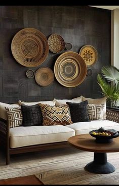 a living room filled with lots of furniture next to a wall covered in plates and bowls