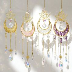 four different types of jewelry hanging from chains