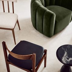 an assortment of modern chairs and stools in a room with white carpeted flooring