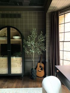 a living room with a guitar on the floor