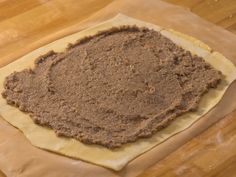 an uncooked pastry sitting on top of a piece of waxed parchment paper