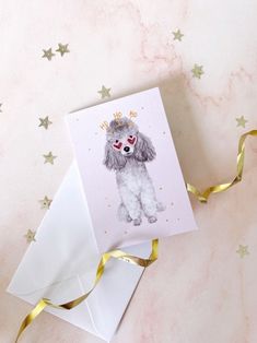 a card with a poodle wearing a crown