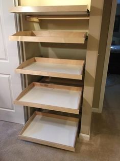 an empty closet with shelves in the corner and carpeted flooring on the other side