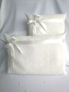 two white pillows with bows on them