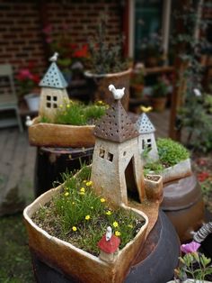 several pots with plants in them sitting on the ground