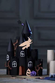 a castle made out of black paper with halloween decorations