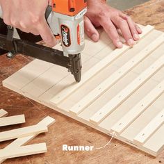 a person using a drill to cut wood planks