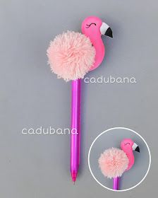 a pink flamingo pen with a fuzzy ball on it