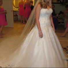 a woman in a wedding dress looking at her reflection