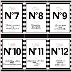 four black and white table numbers with pink lettering on the front, one for each