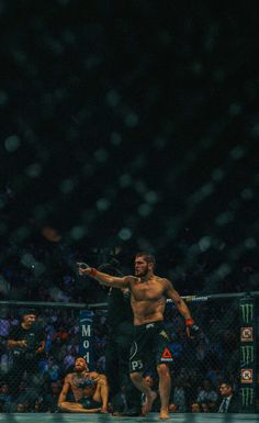 a man standing on top of a wrestling ring