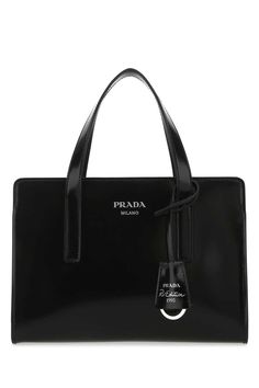 Black leather Re-Edition 1995 handbag Width: 22 cm Height: 15 cm Depth: 7,5 cm Handle height: 10 cm Min shoulder strap length: 42 cm Max shoulder strap length: 56 cmGender: WomenMaterial: 100%CALFColor: BlackMade in: ITProduct ID: 1BA357ZO6 F0002*Import tax/duty will be calculated at checkout (If applicable) Prada Mini, Prada Top, Prada Designer, Prada Handbags, Black Tote Bag, Black Handbags