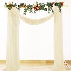 an arch decorated with flowers and greenery