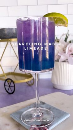 a purple drink sitting on top of a table