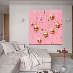 a living room filled with furniture and a pink wall mounted on the side of it