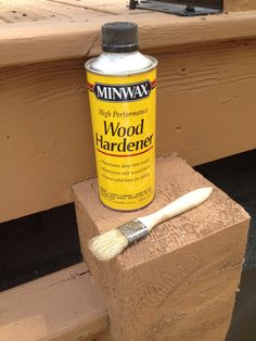 a paint can sitting on top of a piece of wood next to a wooden block