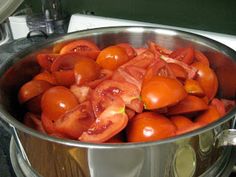 a pot filled with lots of tomatoes on top of a stove