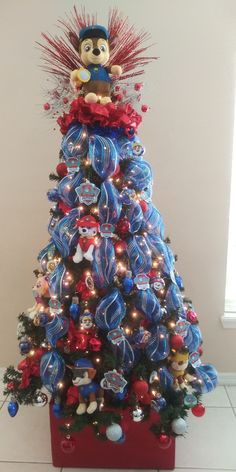 a christmas tree decorated with red, white and blue ornaments