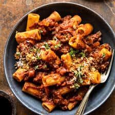 a bowl filled with pasta and sauce on top of a table