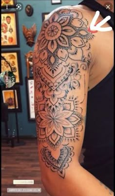 a woman's arm with an intricate tattoo design on the left side of her arm