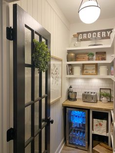 a kitchen with a fridge and shelves filled with food