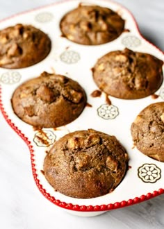 muffins in a red and white tray on a table