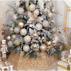 a decorated christmas tree with gold and silver ornaments on the top is surrounded by other holiday decorations