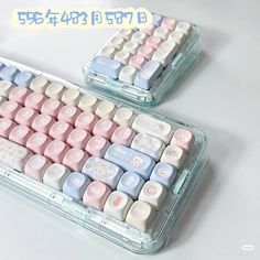 two plastic keyboards with hello kitty keys on them, both in pink and blue colors