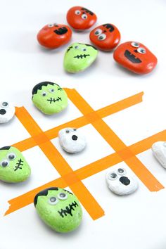 a tic - tac game made out of rocks with faces painted on them