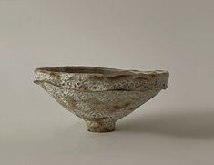 a small bowl sitting on top of a white table