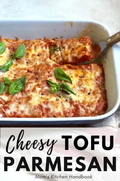 cheesy tofu parmesan in a casserole dish with basil on top