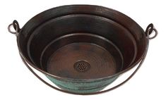 an old fashioned metal bowl with handles on the rim is sitting in front of a white background