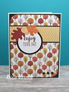 a card with an autumn scene and the words enjoy your day