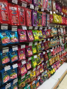 the shelves are filled with various types of candy