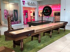 an empty pool table in the middle of a mall