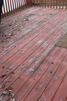 an old wooden deck with peeling paint on it and a fire hydrant in the background