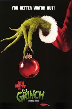 an advertisement for the grin movie, with a hand holding a christmas ornament