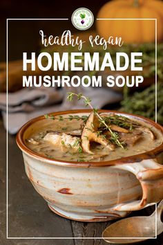 a bowl filled with mushroom soup on top of a wooden table