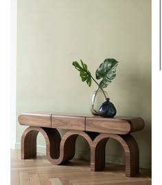 a wooden bench with a plant on top