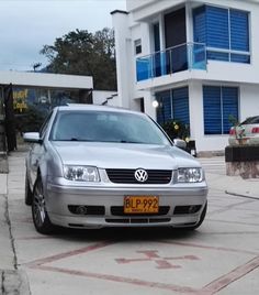 a silver car parked in front of a building