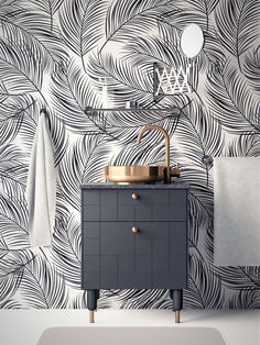 a bathroom with black and white wallpaper, gold faucet, sink and mirror