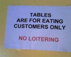 a sign that says tables are for eating customers only no loitering on it